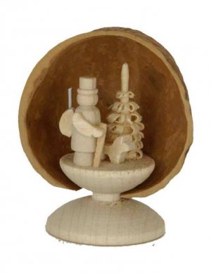 Miniature forest ranger in walnut shell, standing