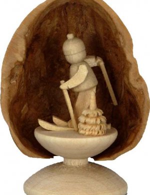 Miniature skier in walnut shell, standing