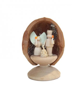 Miniature angel and miner in walnut shell, standing