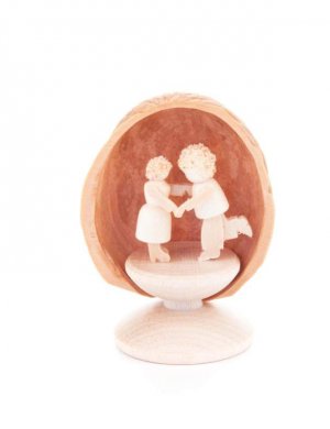Miniature dancing couple in walnut shell, standing