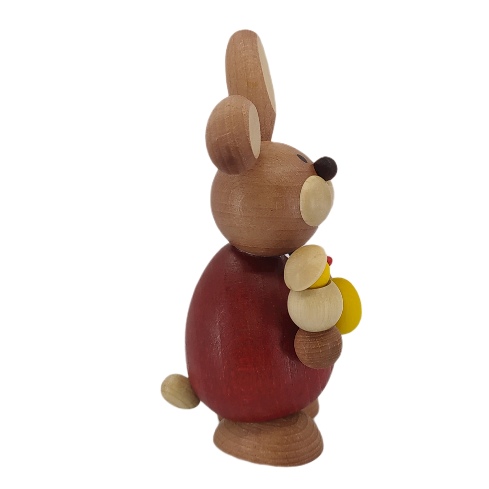 Easter bunny standing with hatching chicks