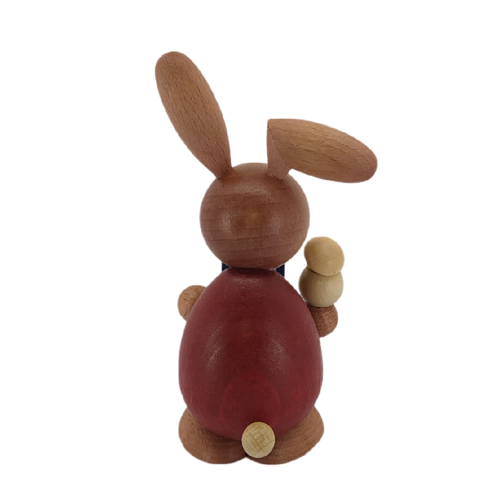 Easter bunny standing with hatching chicks
