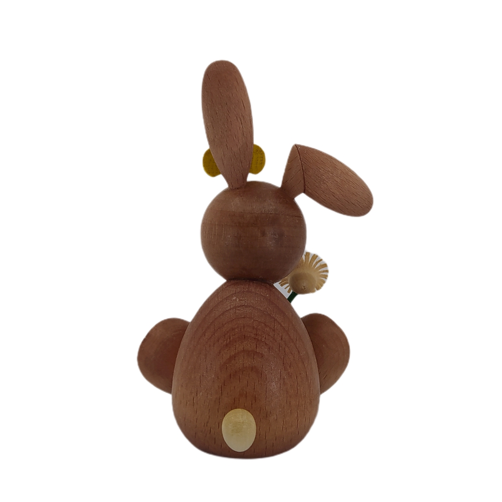 Easter bunny sitting with ladybug and flower