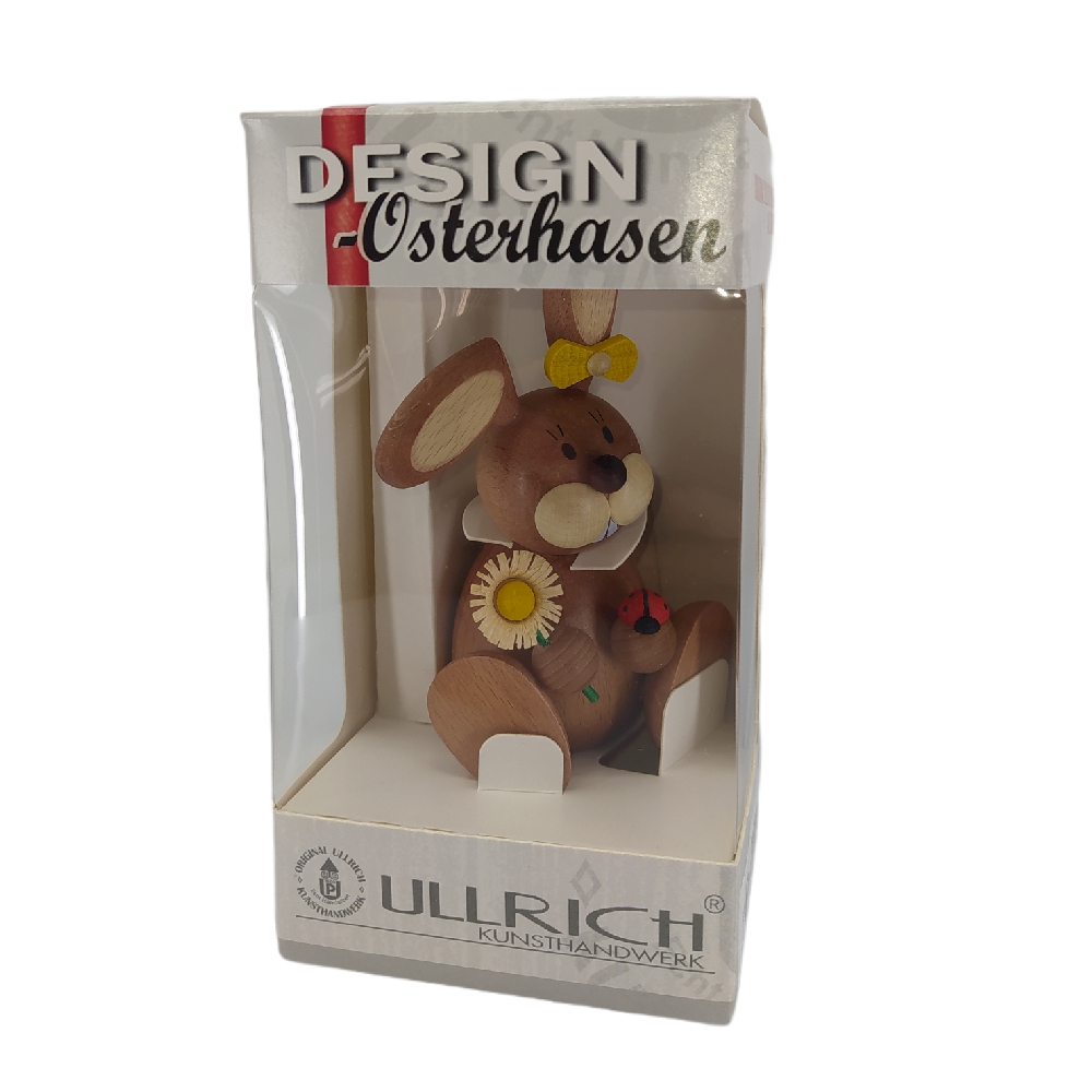 Easter bunny sitting with ladybug and flower
