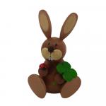 Easter bunny sitting with shamrock and ladybug