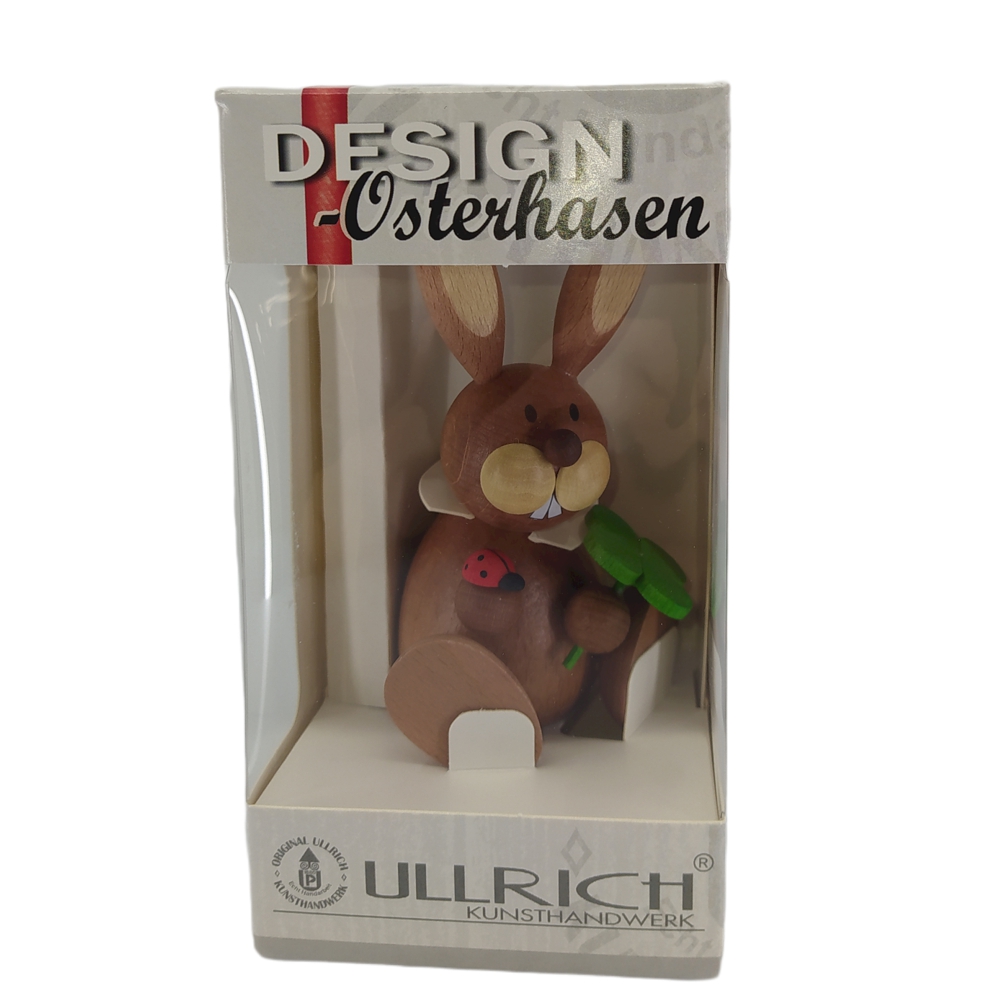 Easter bunny sitting with shamrock and ladybug