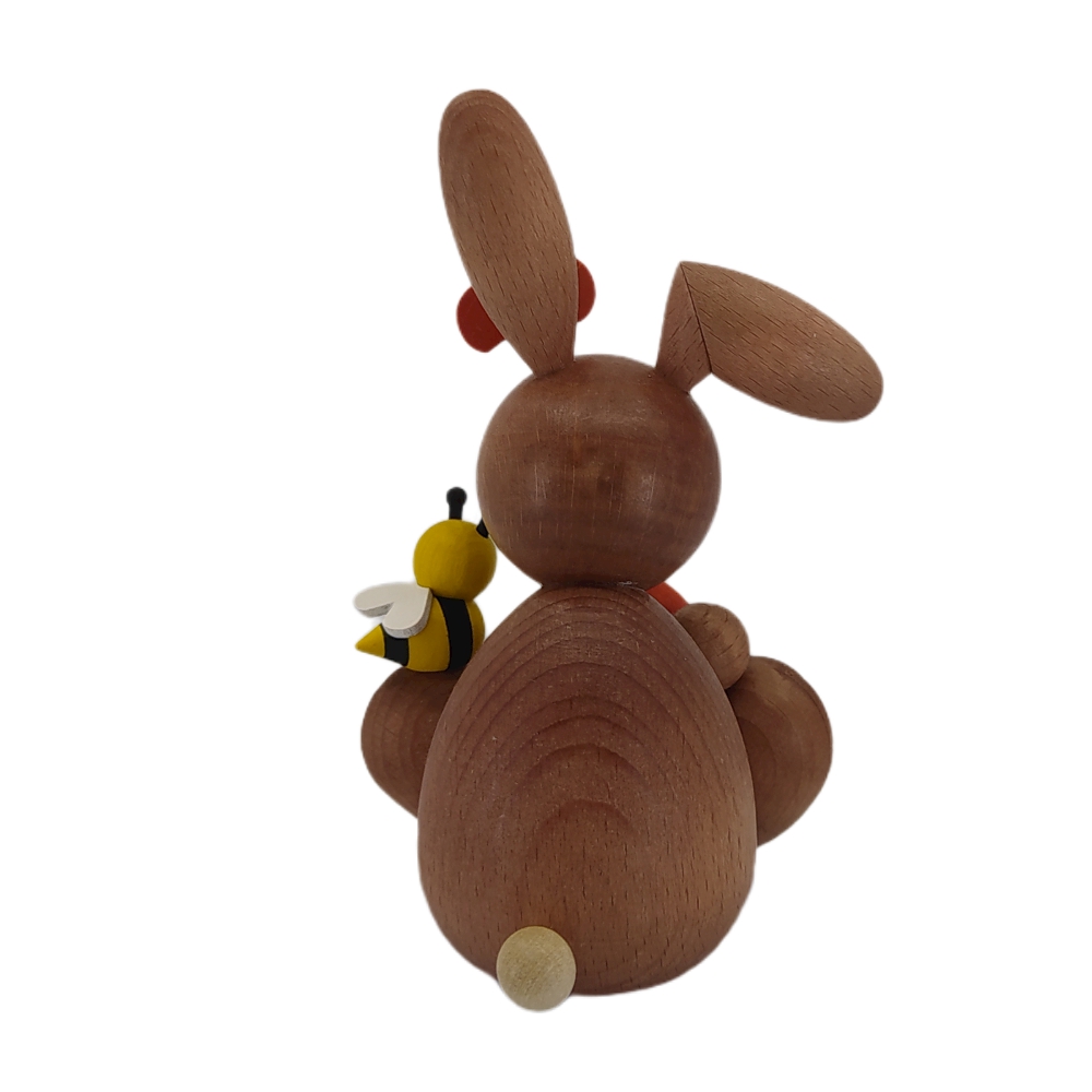 Easter bunny sitting with egg and bee