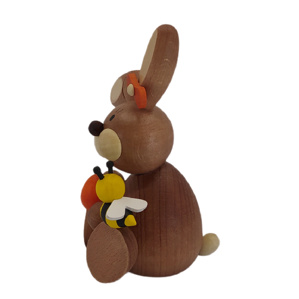 Easter bunny sitting with egg and bee