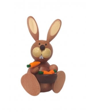 Easter bunny sitting with carrot bowl