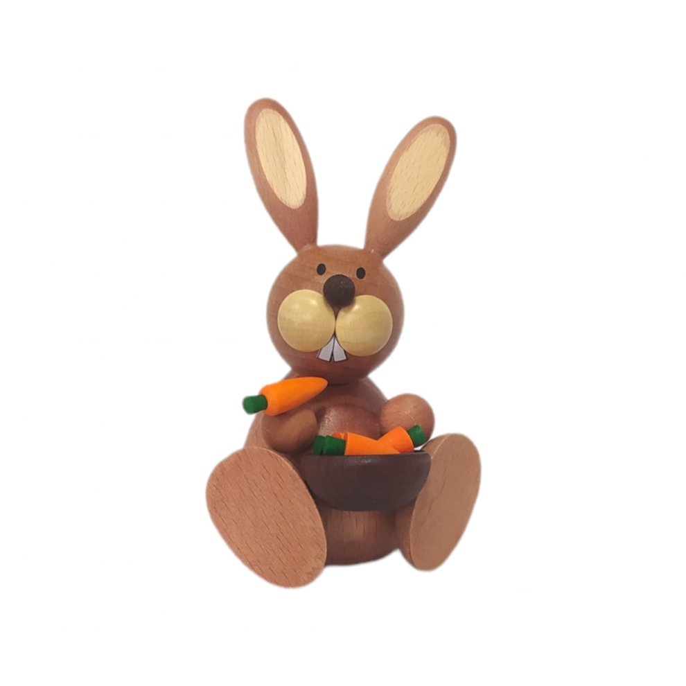 Easter bunny sitting with carrot bowl