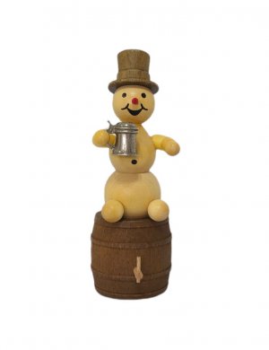 Snowman with mug on beer barrel