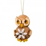 Hanging owl child with snow crystal