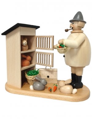 Smoking man rabbit breeder with rabbit hutch