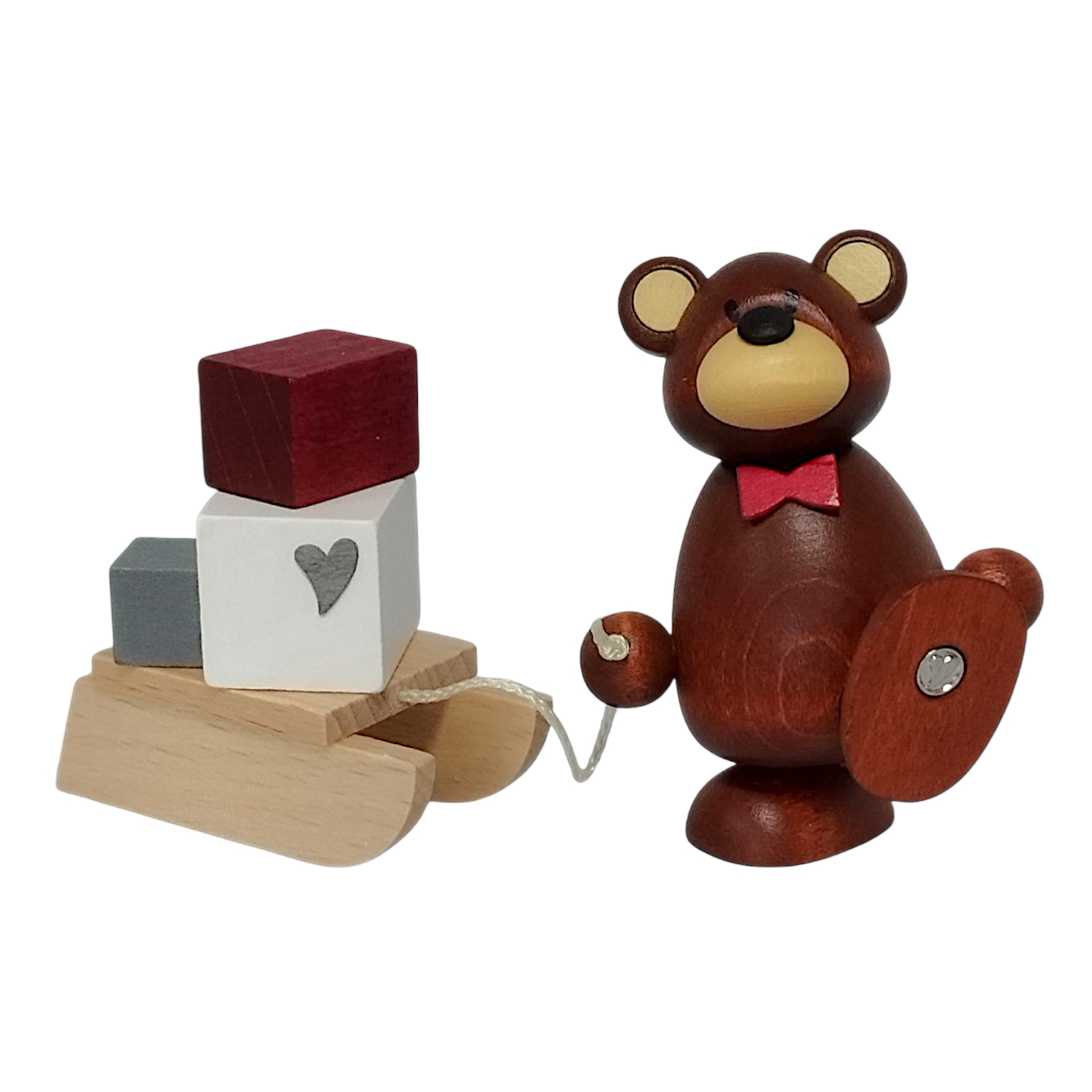 Figure with heart, bear with gift sleigh