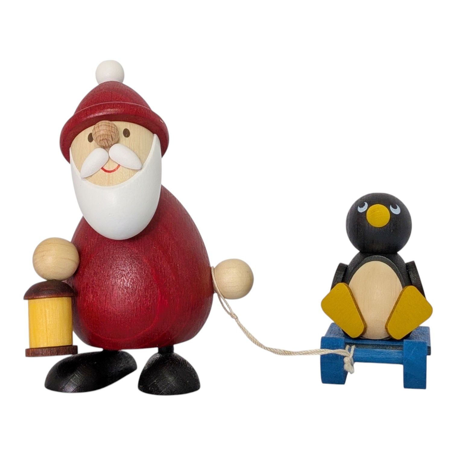 Weihnachtsmann mit Schlitten und Pinguin